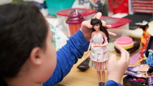 Mattel's free Barbie doll initiative rolled out in UK schools, has sparked backlash and criticism, with experts labelling it as "stealth marketing" and "repulsive "in the British Medical Journal (BMJ). The photo shows a young child playing with a doll.
