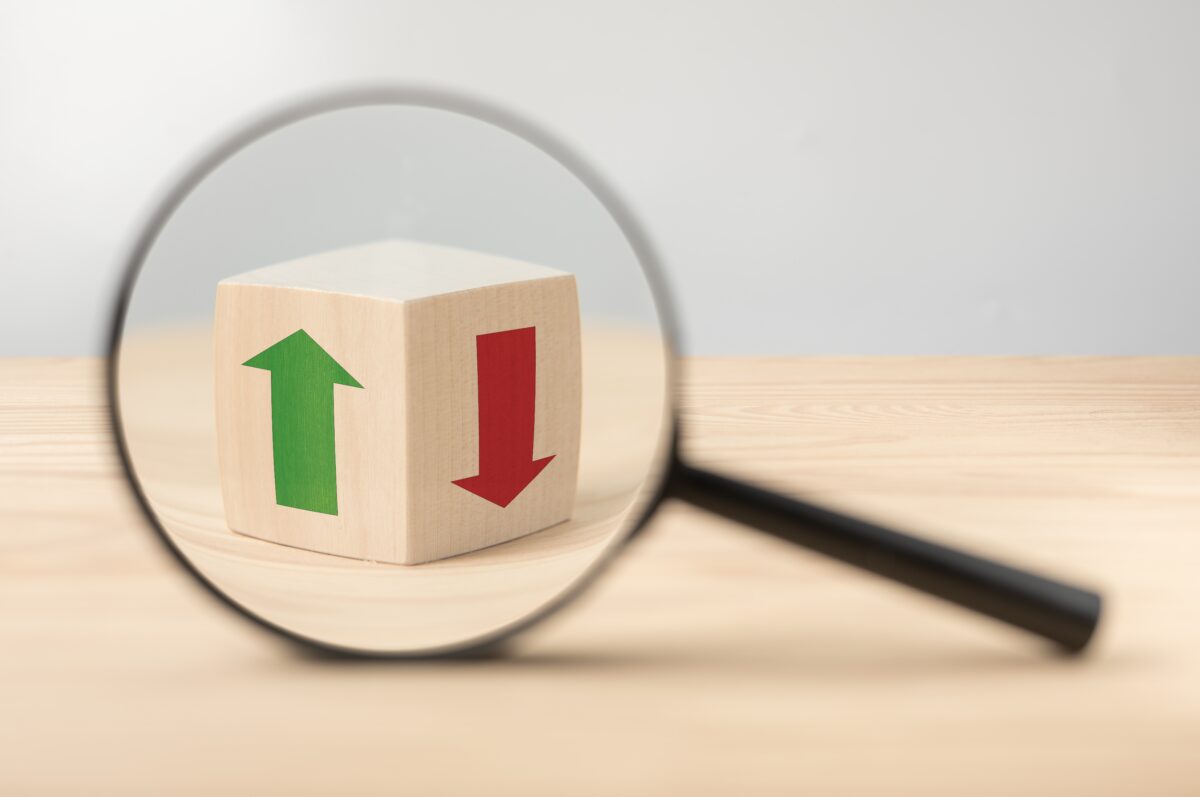Ad holding companies have had polar opposite Q3 results, with Havas noting impressive growth, while Interpublic (IPG) reports struggles, here depicting a magnifying glass showing a wooden cube with a green growth arrow and a red decline arrow