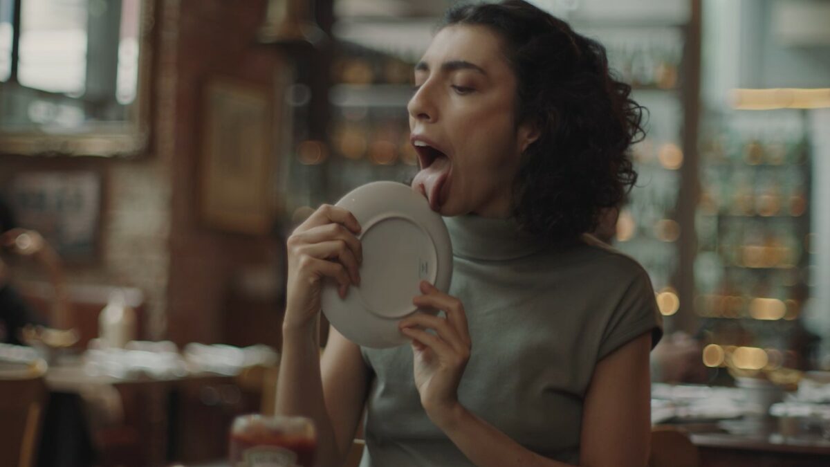 Screenshot showing image from latest Heinz ads showing a woman gleefully licking the iconic ketchup off a plate. Heinz pays tribute to those who are willing to go the extra mile in its latest ad, which spans digital and print.