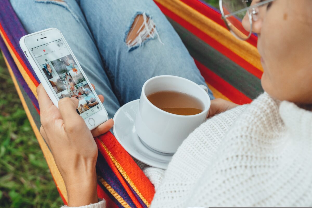 A woman in a colourful hammock aimlessly scrolls through Instagram - cup of tea in hand. Instagram is testing adverts that users are unable to skip past, in a controversial new move which will see a timer count down to zero before they can scroll again.