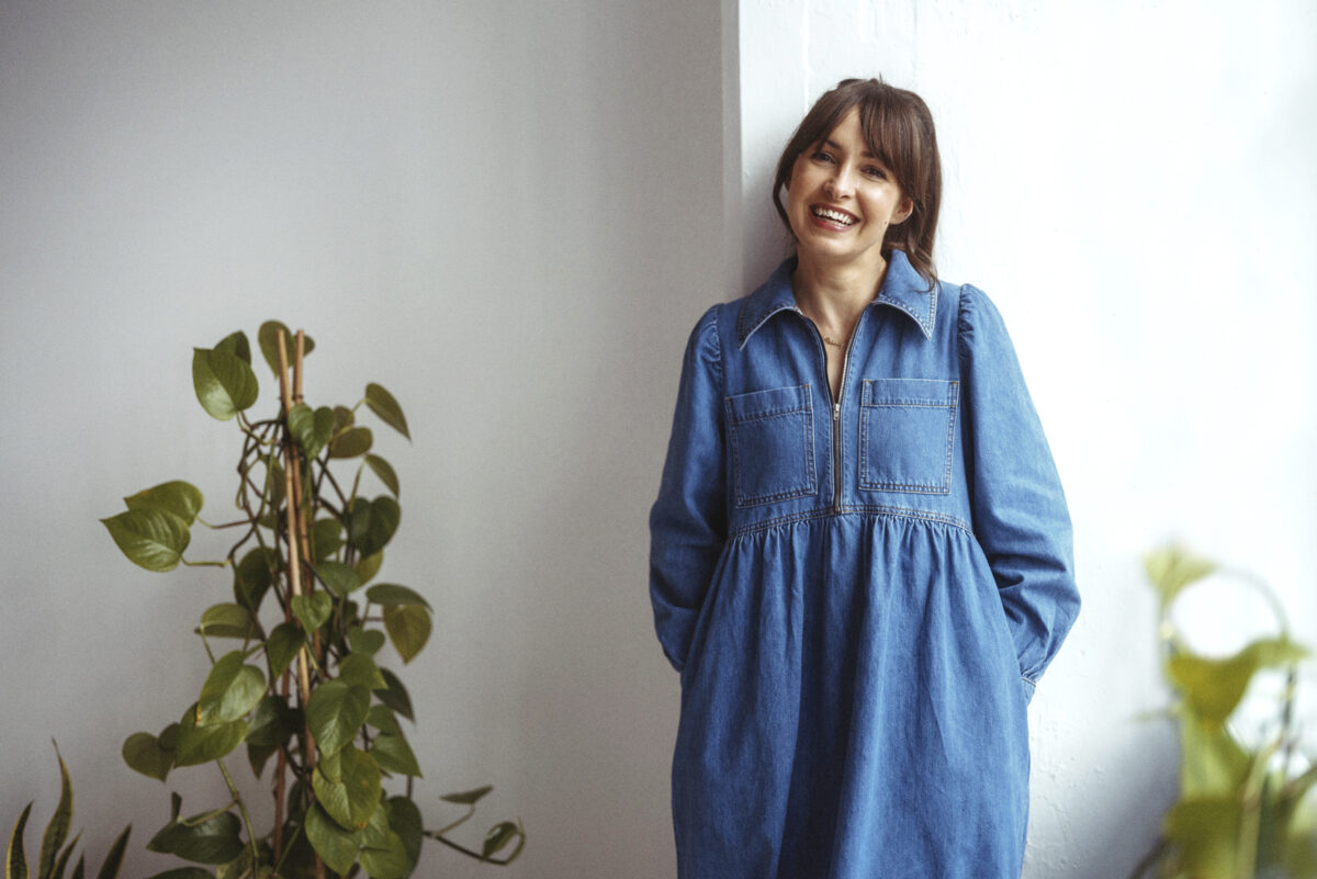 Hollie Walker stands in a blue denim dress against a wall. Mother has poached its new award-winning executive creative director  from Wieden + Kennedy.